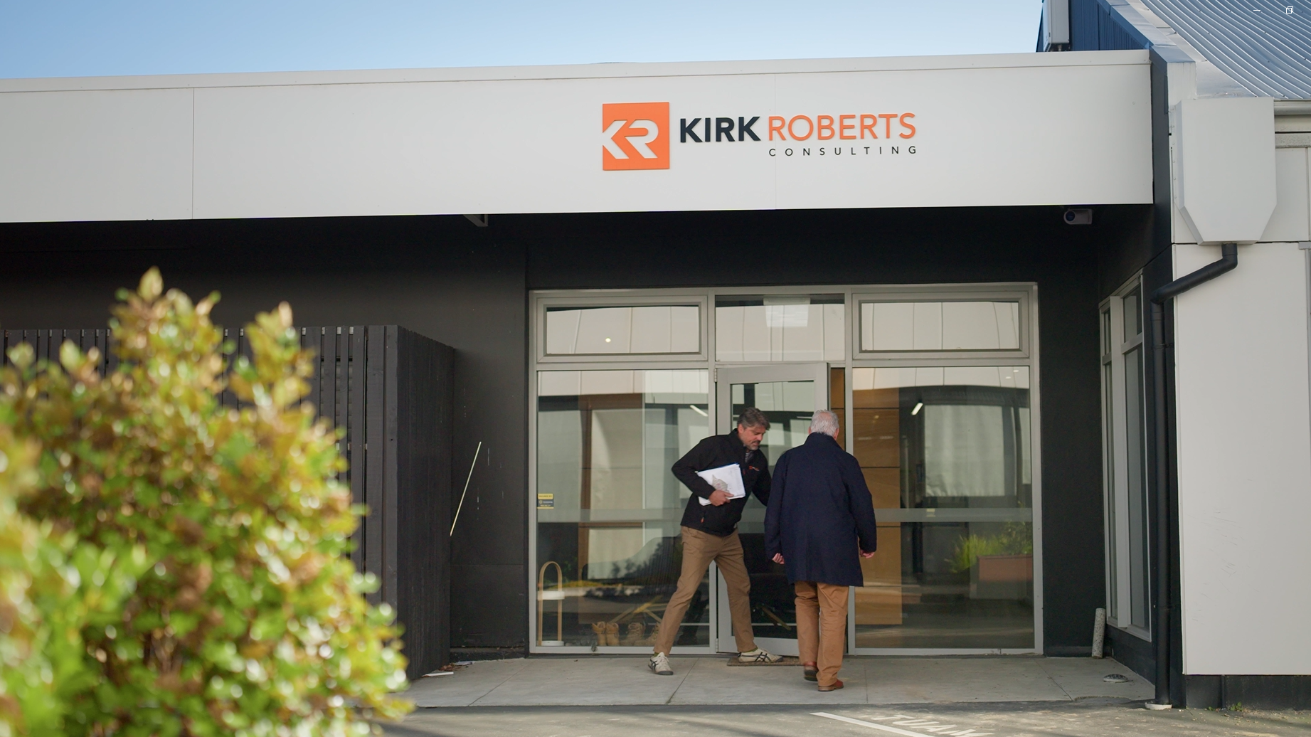 Kirk Roberts employee opening door to the Christchurch office for client